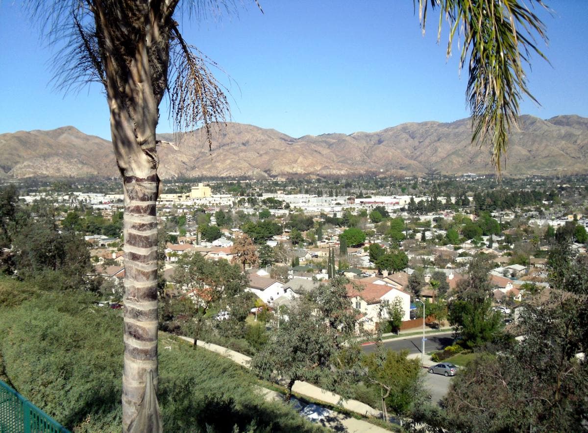 Suburban rooftops below dry mountains
