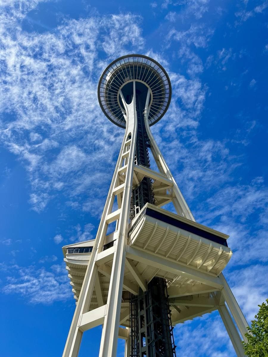 The Space Needle seen from its base against a bright blue sky