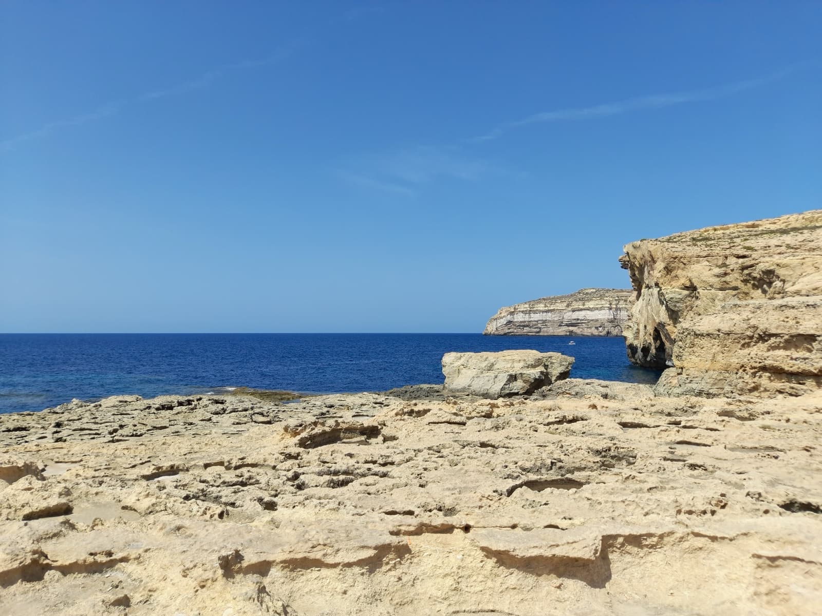 Cliffs and open sea where a rock arch used to stand