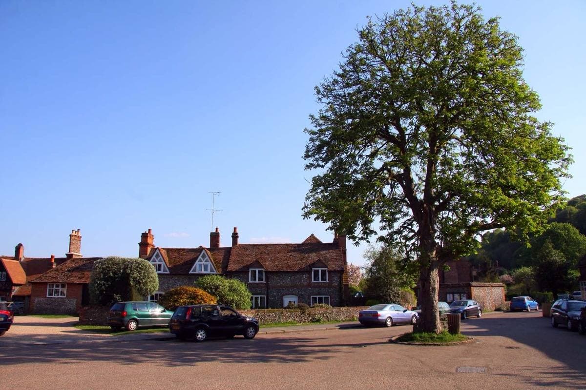 Brick and flint cottages around a small village square