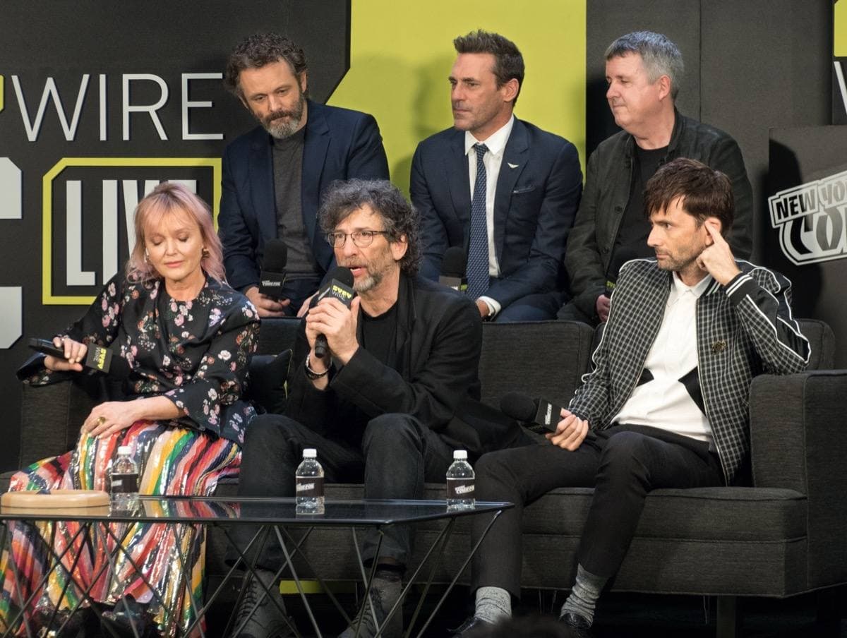 Six people seated in two rows at a convention panel