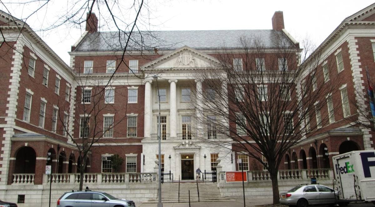 A red-brick Georgian museum with a white portico behind a raised forecourt