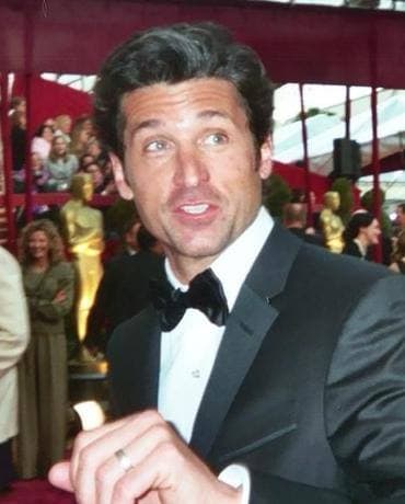 Patrick Dempsey in a dark suit on a red carpet