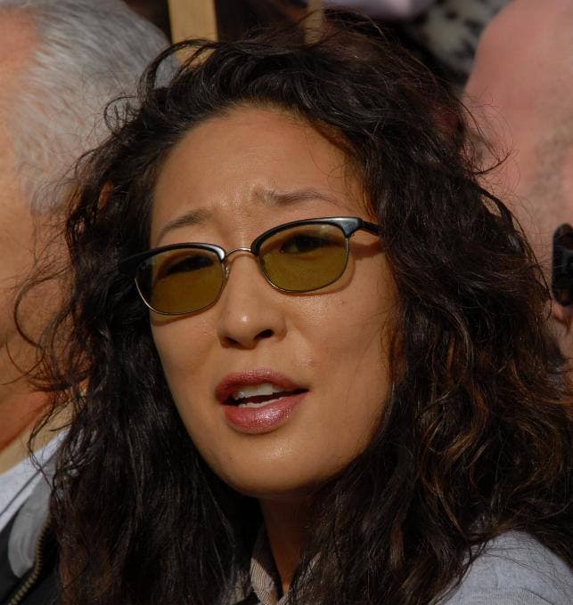 Sandra Oh smiling, dark curly hair