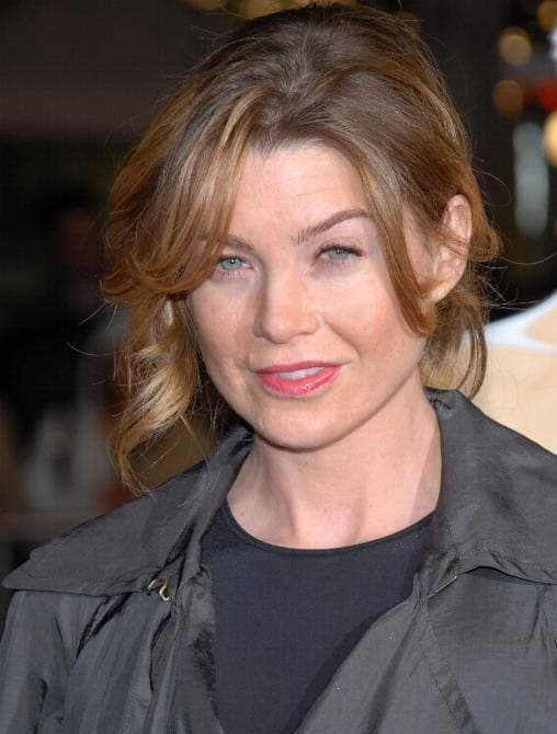 Ellen Pompeo smiling, dark hair down, at an evening event