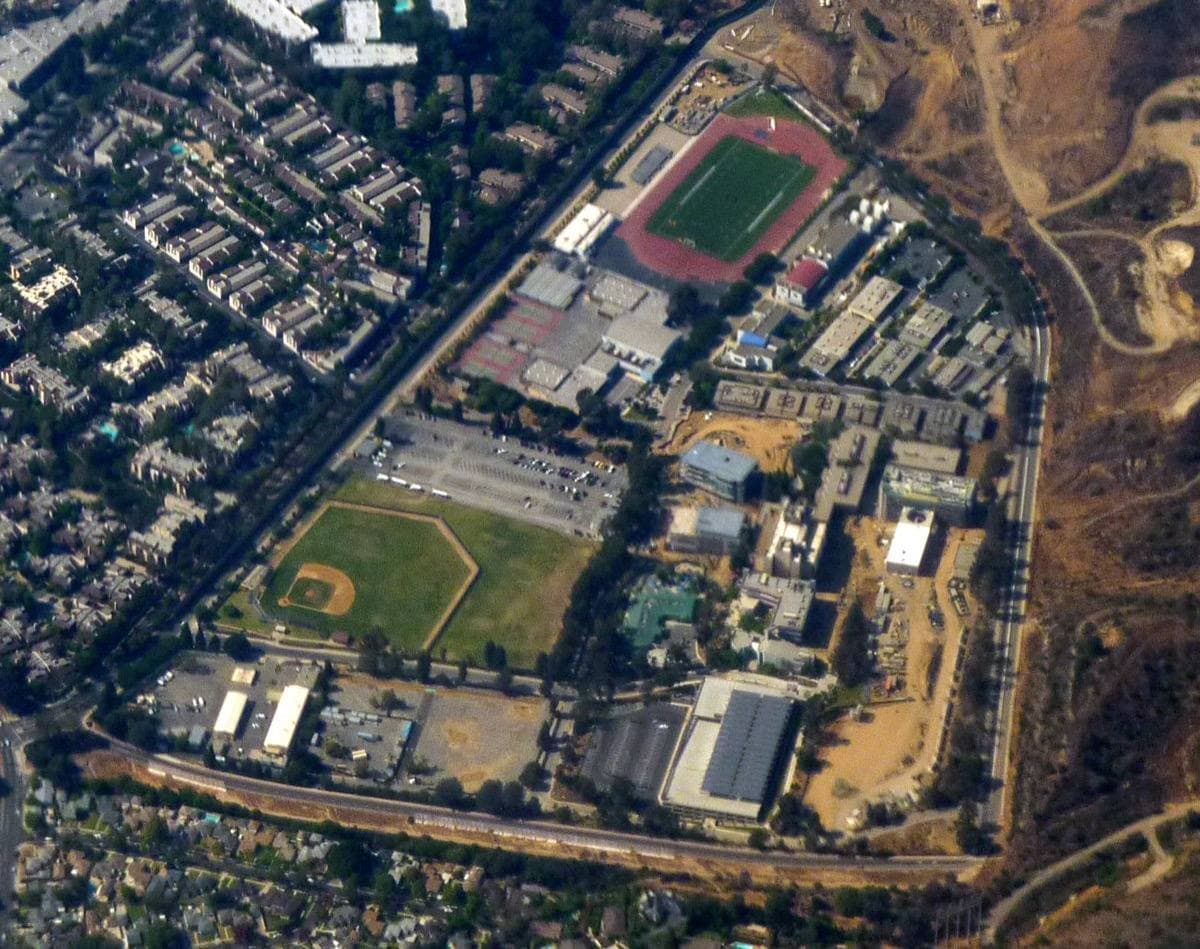 College buildings on a green hillside campus