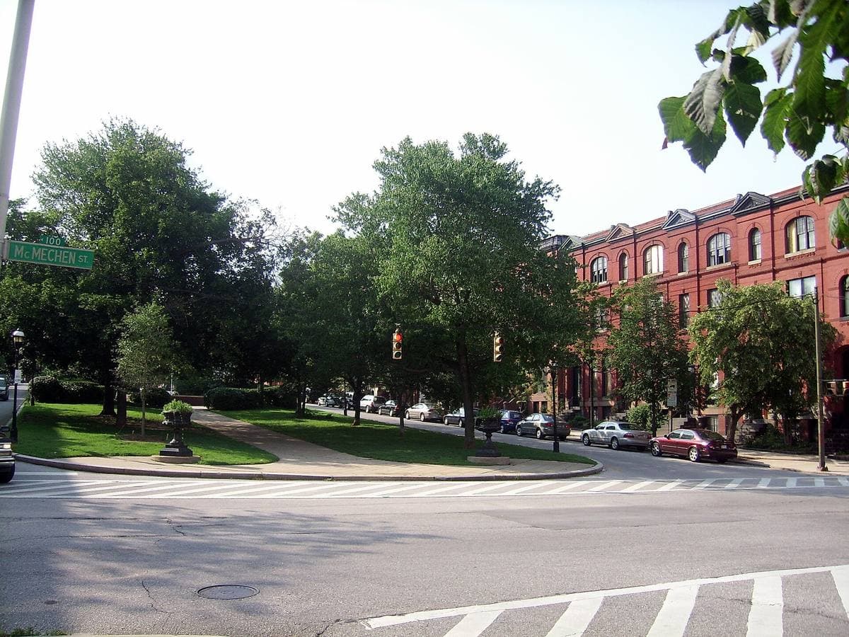 A street of red-brick rowhouses with white marble steps