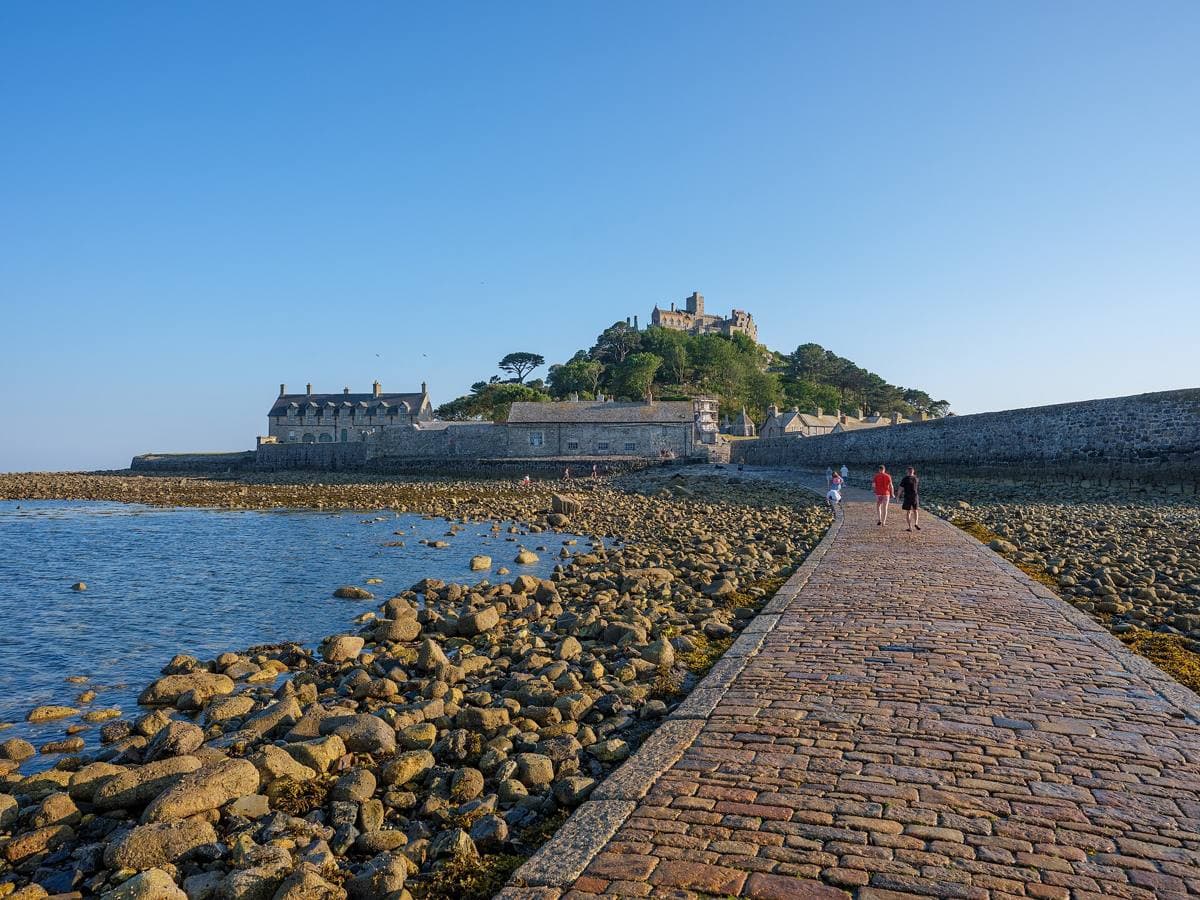 A castle on a rocky tidal island in the evening light, the sea around it