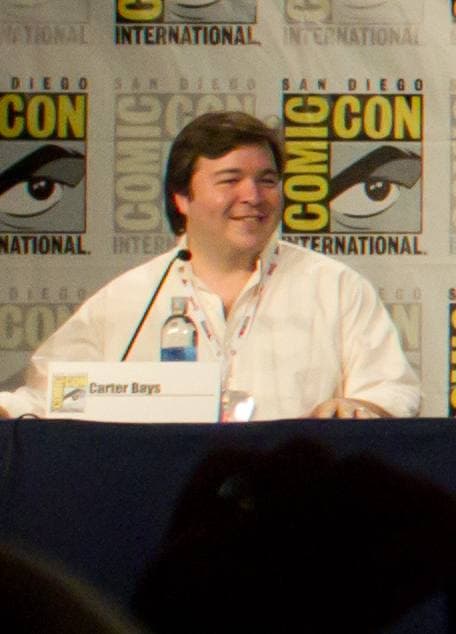 A man with dark hair speaking at a panel table