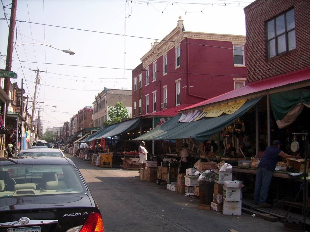 Market stalls with awnings along a street