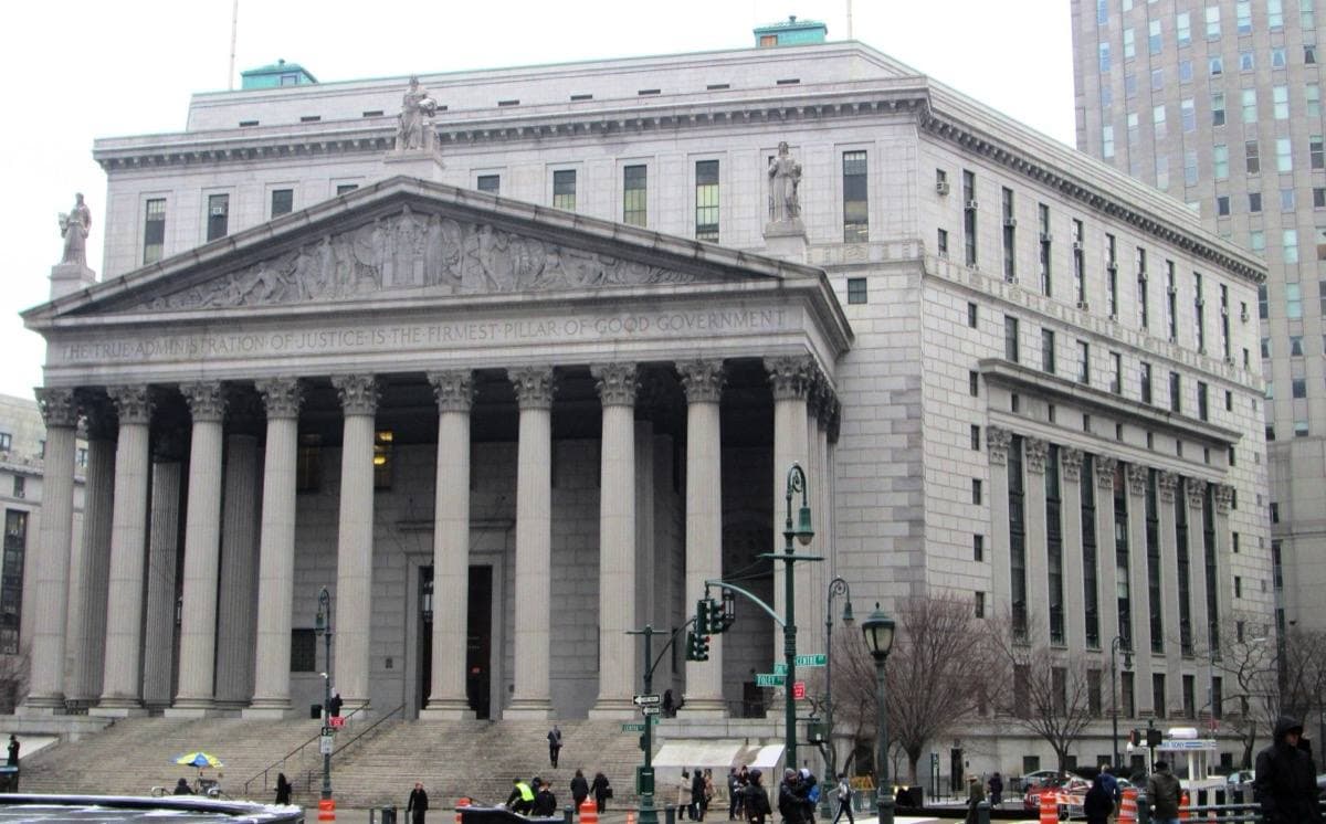 A wide granite courthouse with a long portico of columns above a broad flight of steps