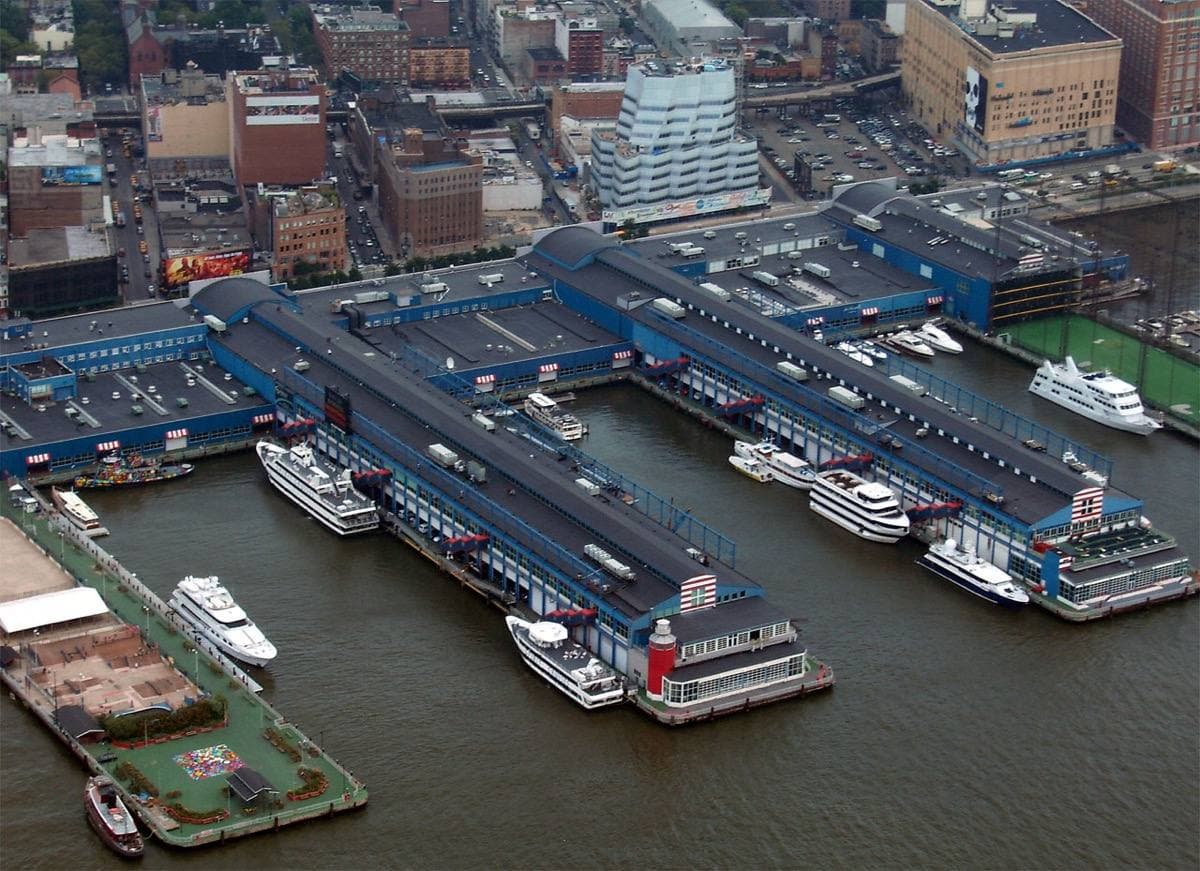 An aerial view of long pier buildings stretching into the Hudson River
