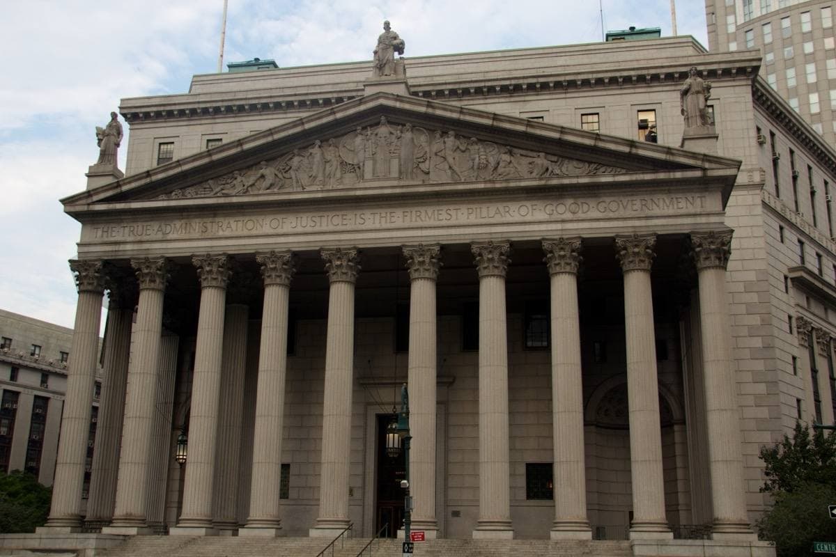 Granite steps rising to a row of Corinthian columns