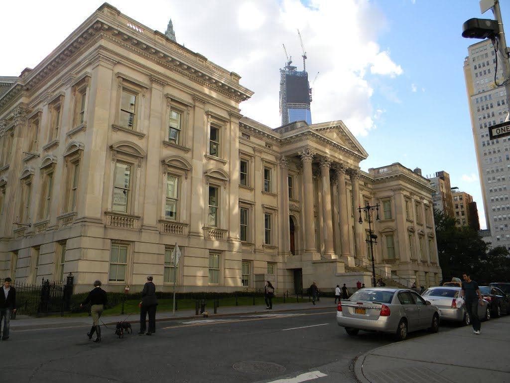 A white marble courthouse with a pedimented portico and tall steps