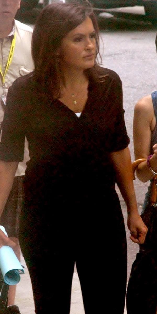 A woman with long dark hair in a dark jacket on a New York street