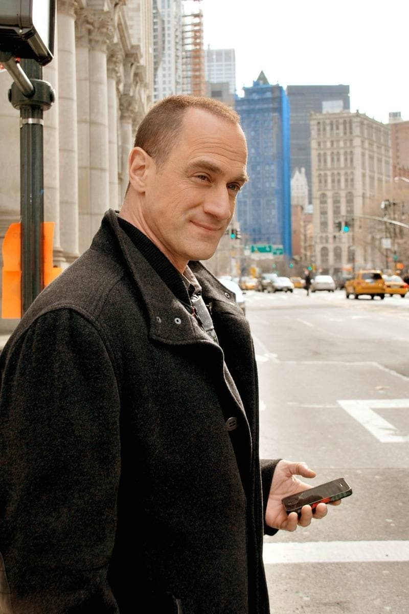 A man in a suit standing on a city pavement