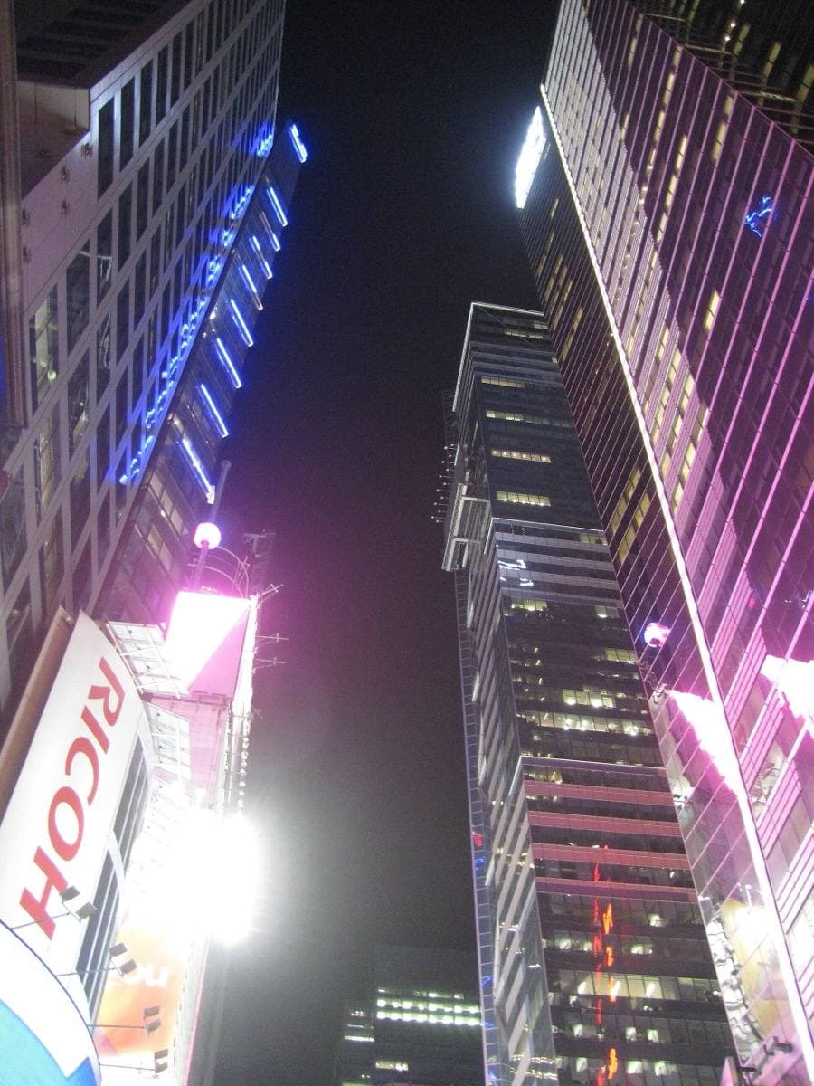 Tall office towers along 42nd Street at night