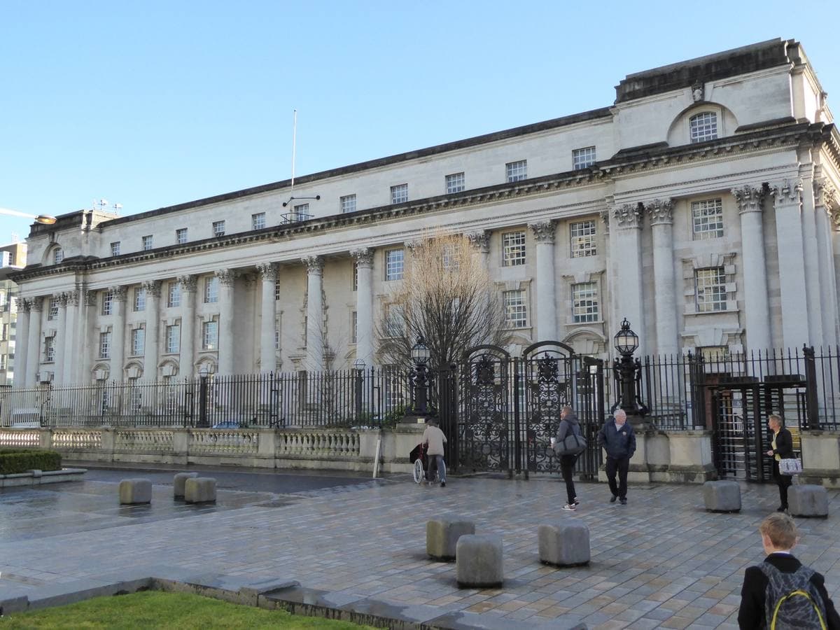 A massive pale stone court building with a colonnade of tall columns