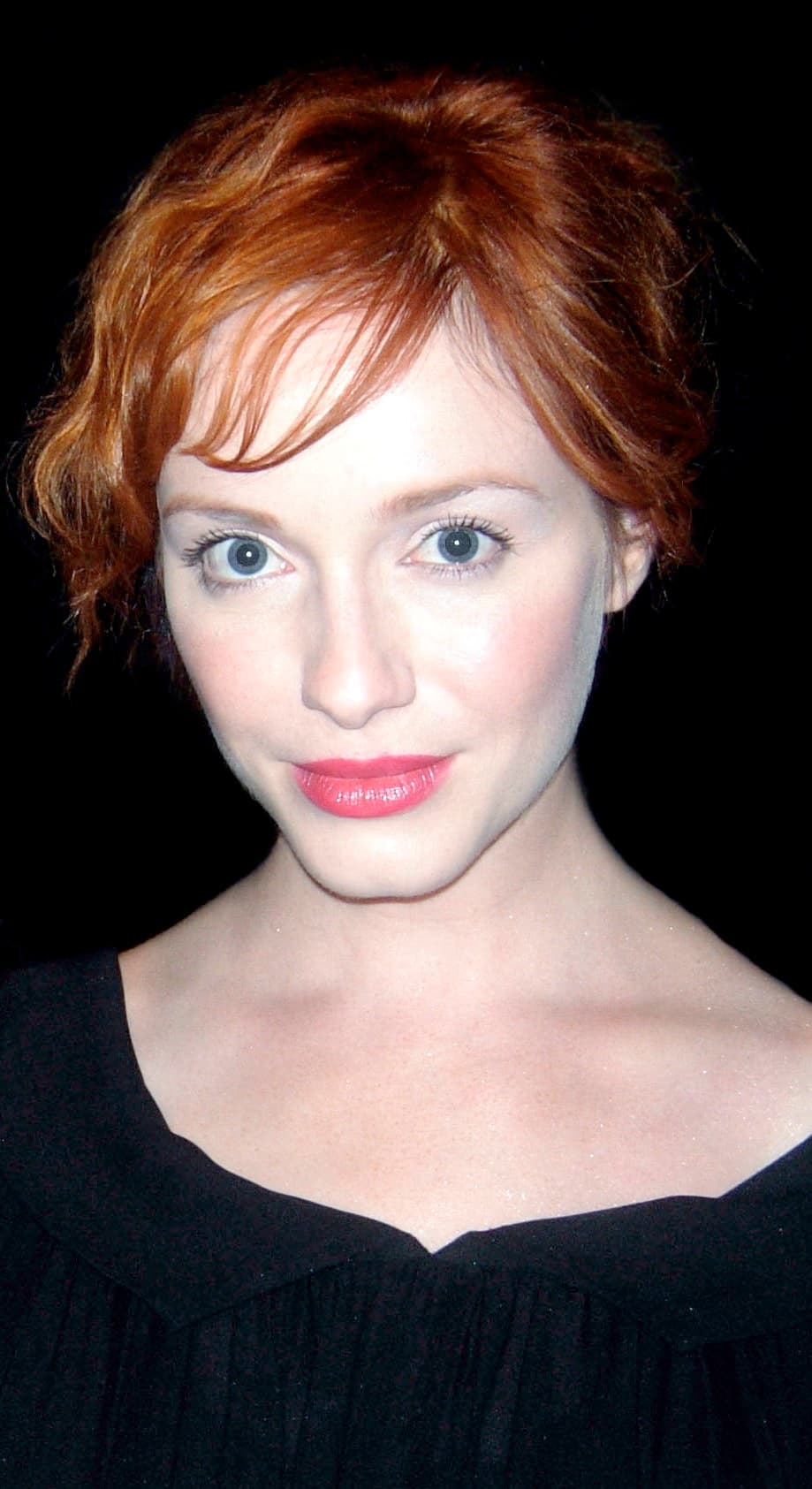 Christina Hendricks with red hair against a dark background