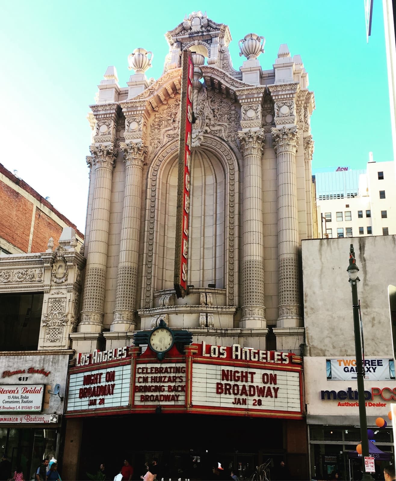 The ornate tall façade and marquee of the Los Angeles Theatre