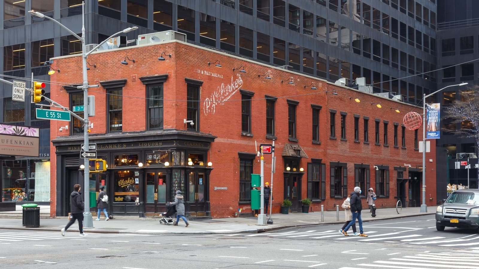 A small red-brick corner bar beneath midtown office towers
