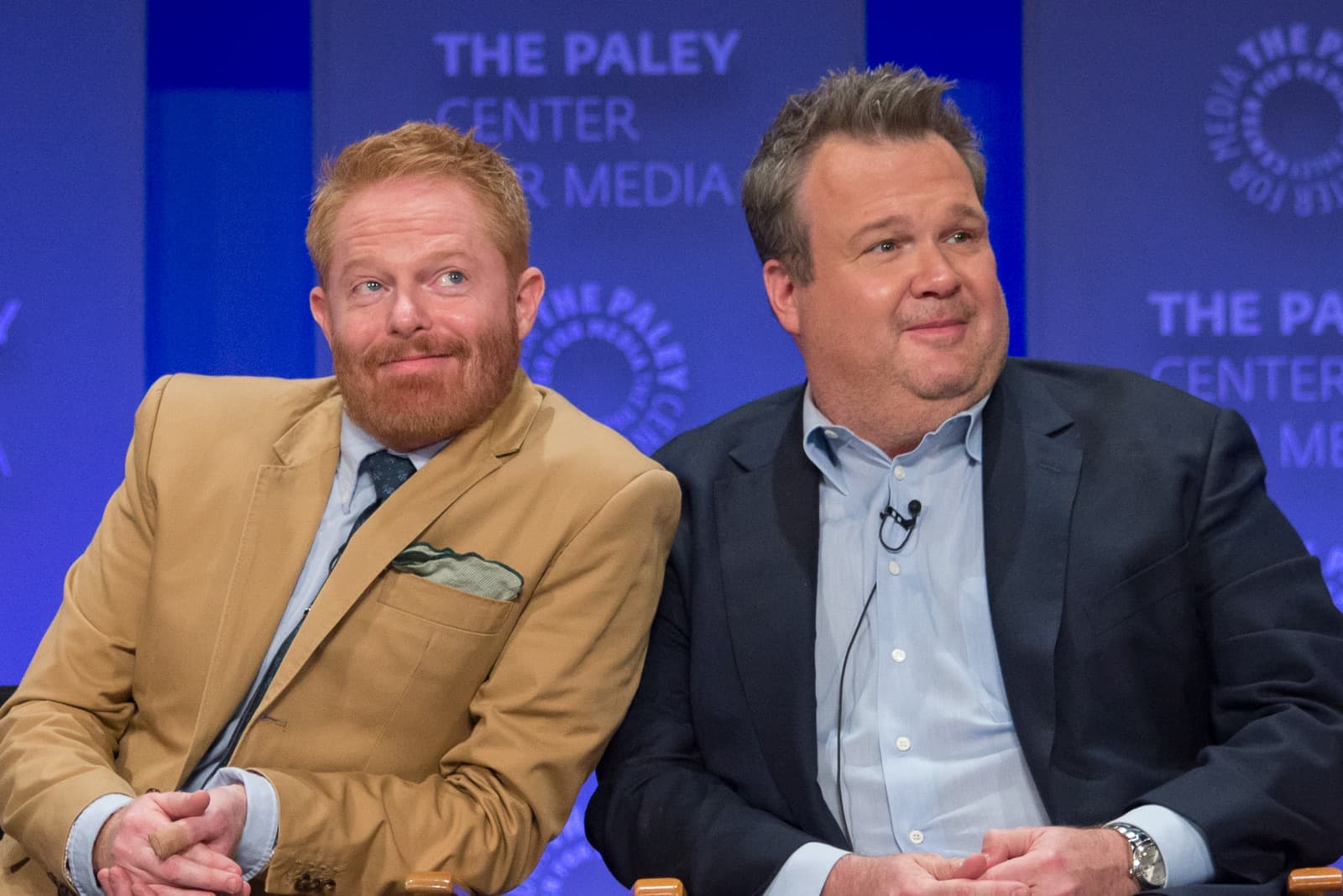 Jesse Tyler Ferguson and Eric Stonestreet side by side on a panel stage