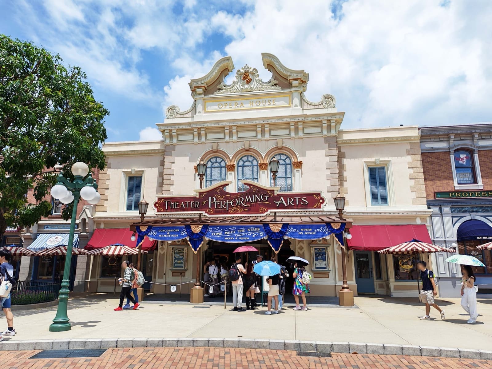 A cream and gold Victorian theatre front on Main Street with bunting