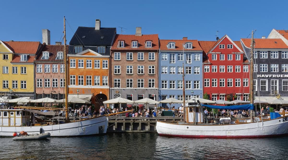 A canal lined with brightly painted houses and old wooden boats