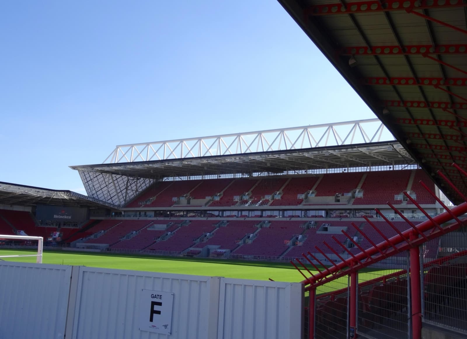 Red seats and a curved roof inside Ashton Gate stadium