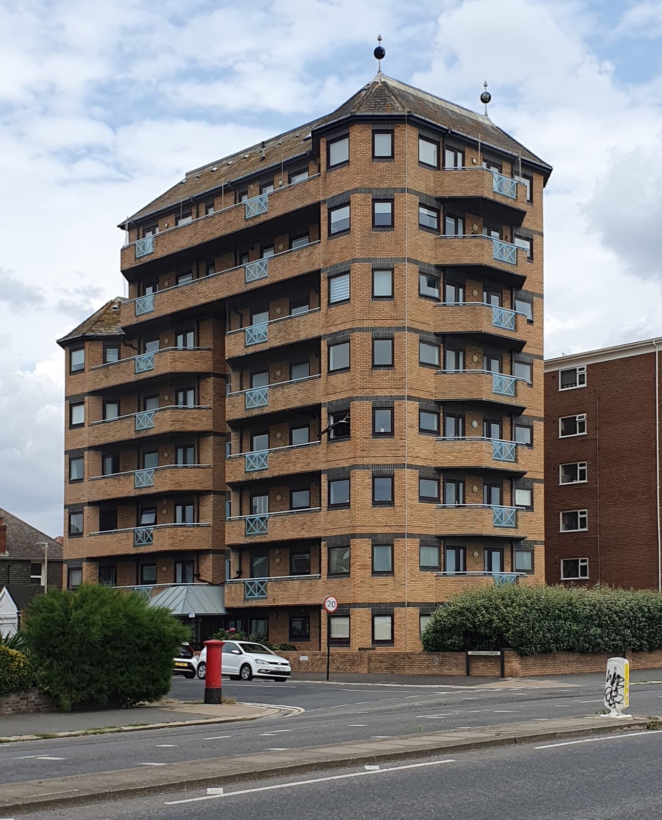 A brown-brick block of seaside flats on a corner