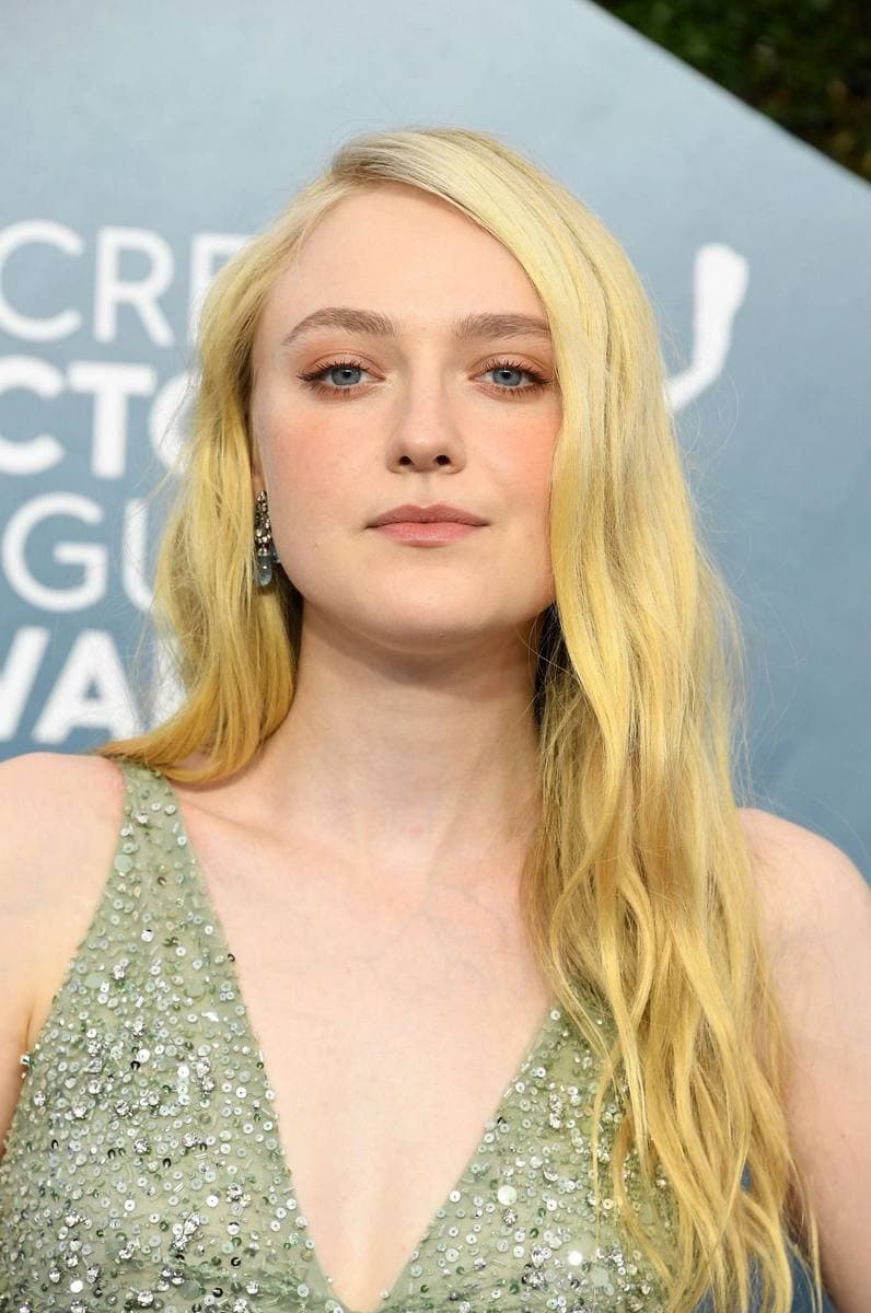 Dakota Fanning with long blonde hair in a pale sequinned dress