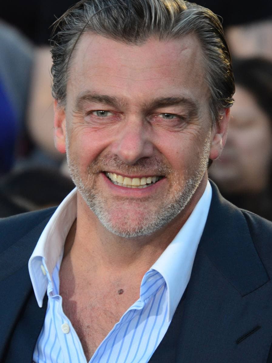 Ray Stevenson smiling in an open-necked shirt