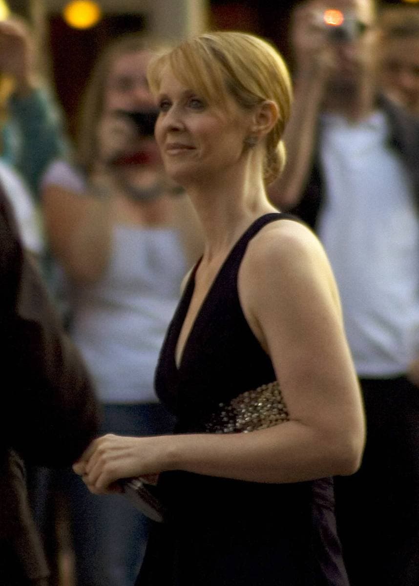 Cynthia Nixon, red hair pinned back, in a dark sleeveless dress