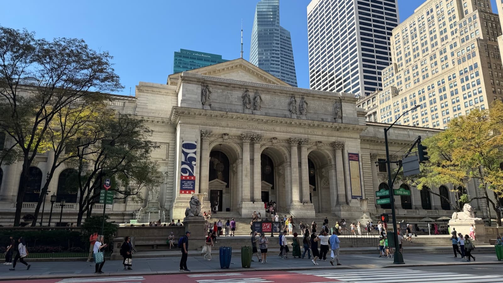 The white marble library front with its columns, steps and crowds on Fifth Avenue
