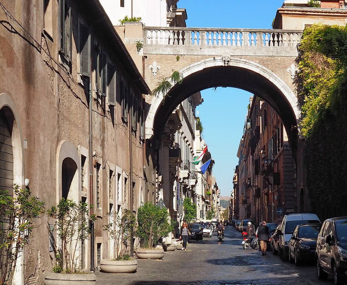 An ivy-hung arch spanning a quiet cobbled street