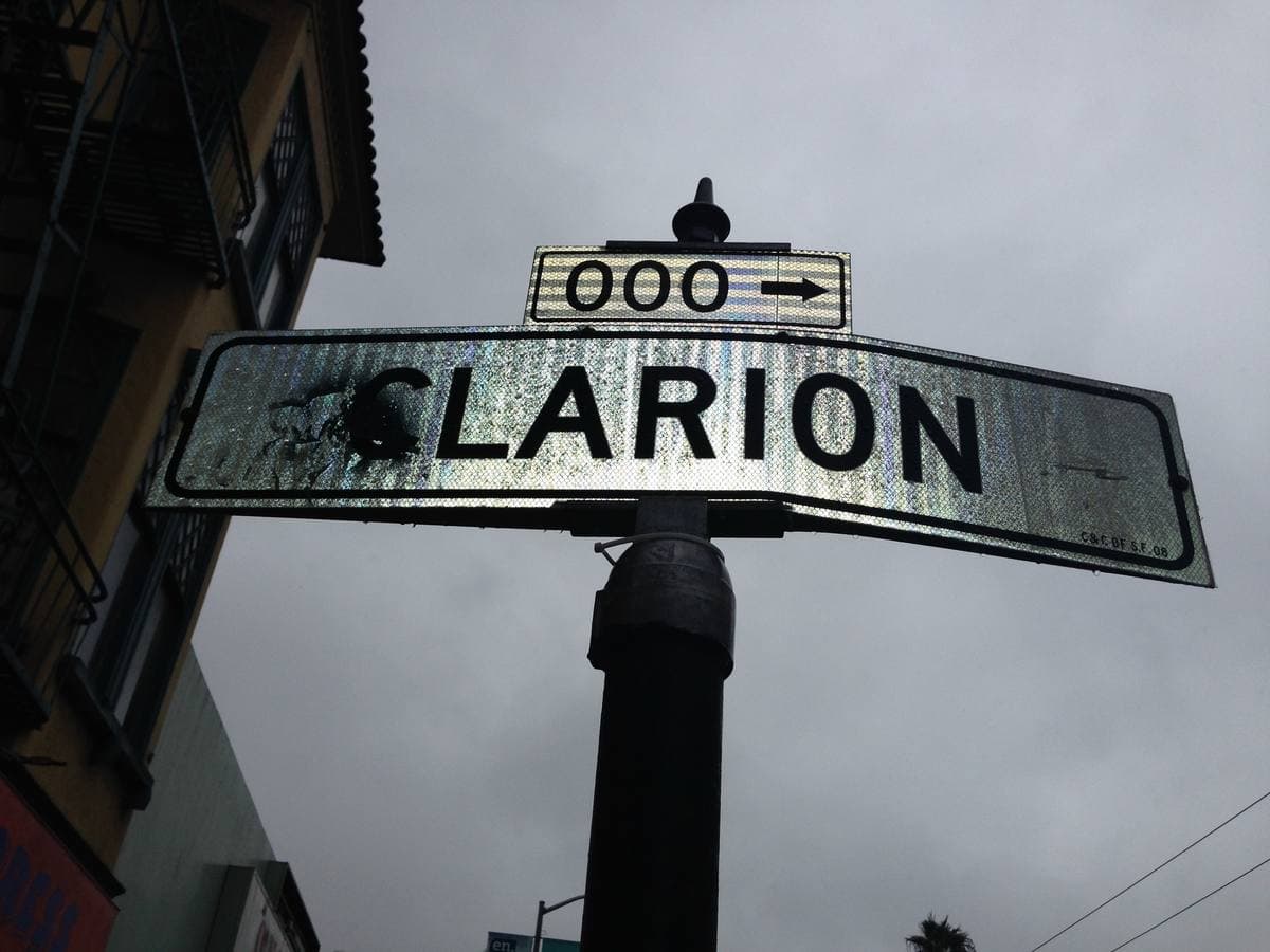 A Clarion street sign against a grey sky