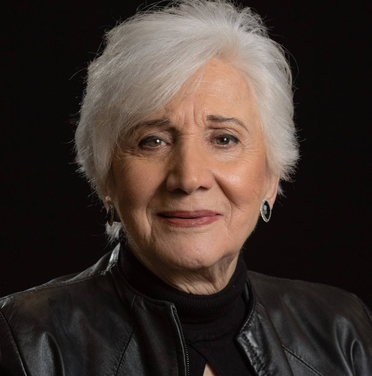 Olympia Dukakis with short white hair, smiling