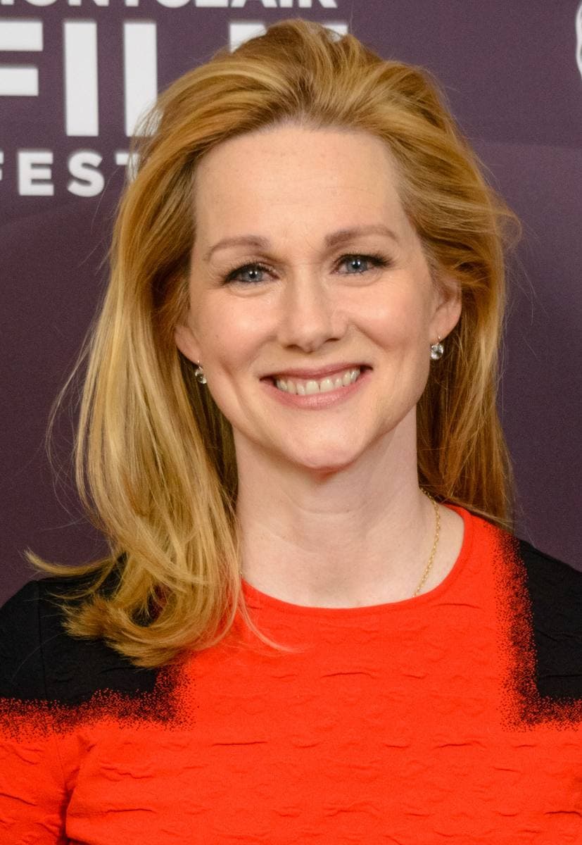Laura Linney smiling in a red top