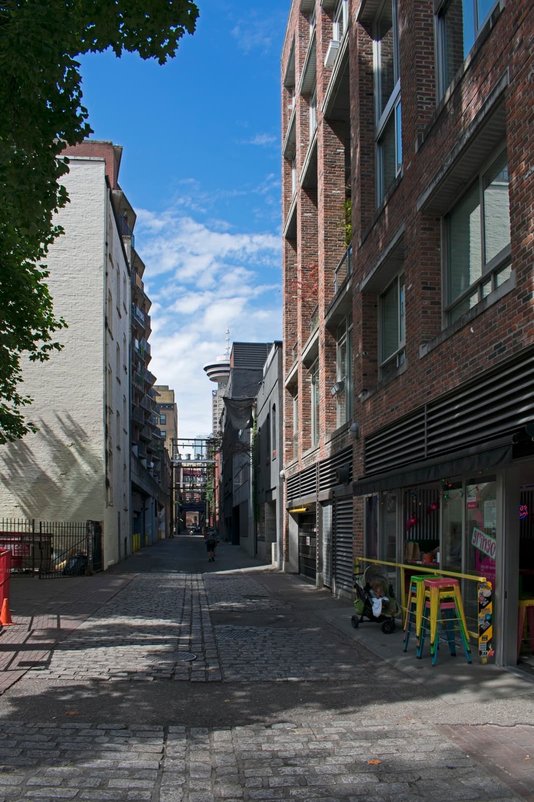 A narrow cobbled alley between brick buildings in Gastown