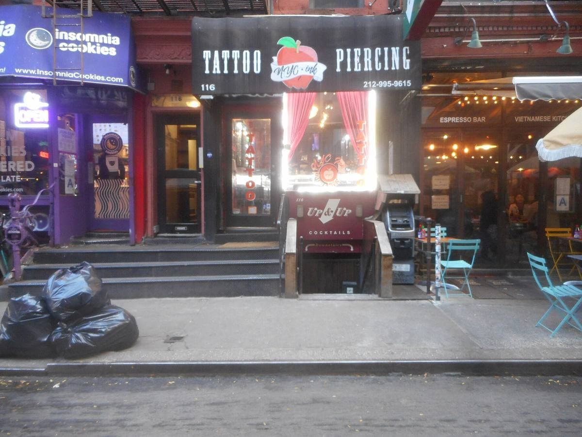 The front of 116 MacDougal Street, with the Up & Up bar and a tattoo studio