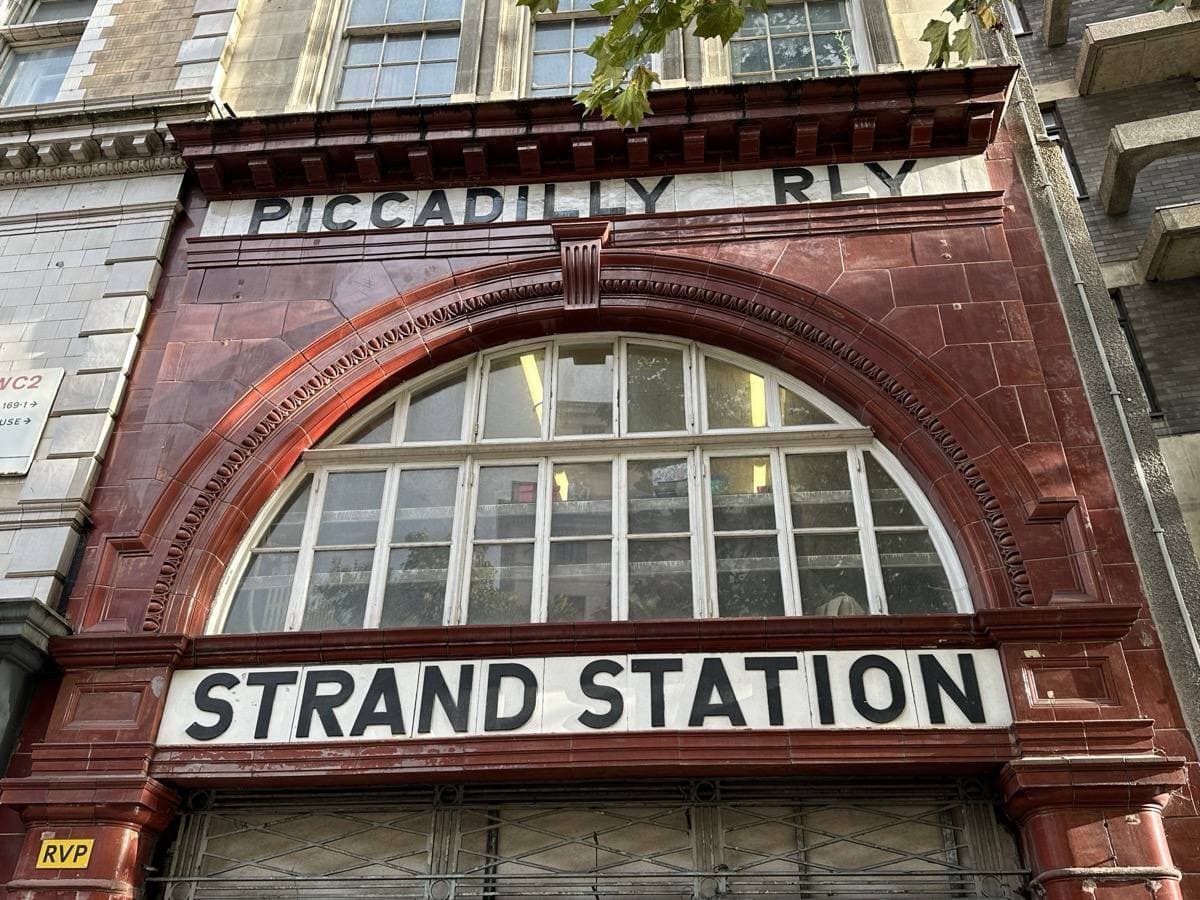 An oxblood-tiled station front on a London street