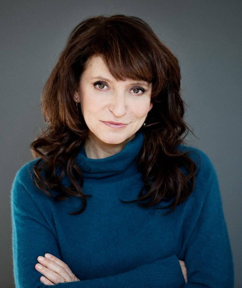 Susanne Bier smiling, dark curly hair
