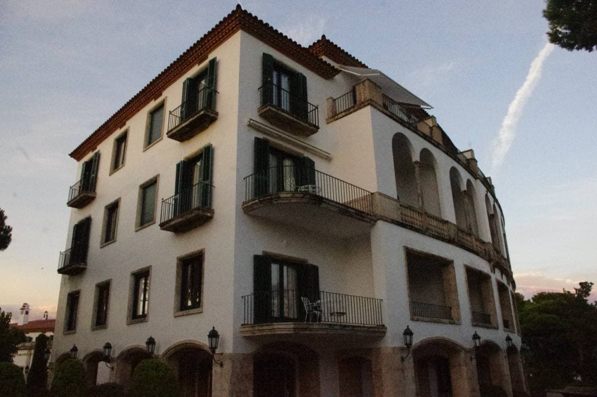 A white Mediterranean hotel above the sea among pines