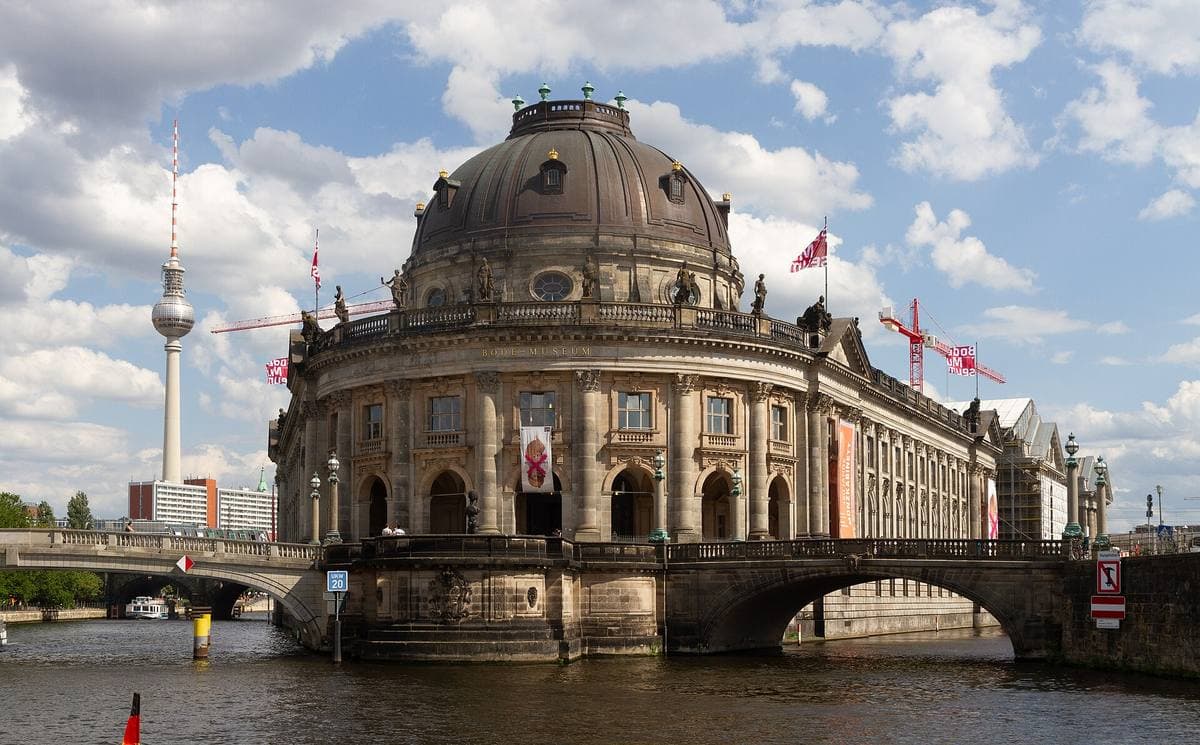 A domed neo-baroque museum rising from the river at dawn