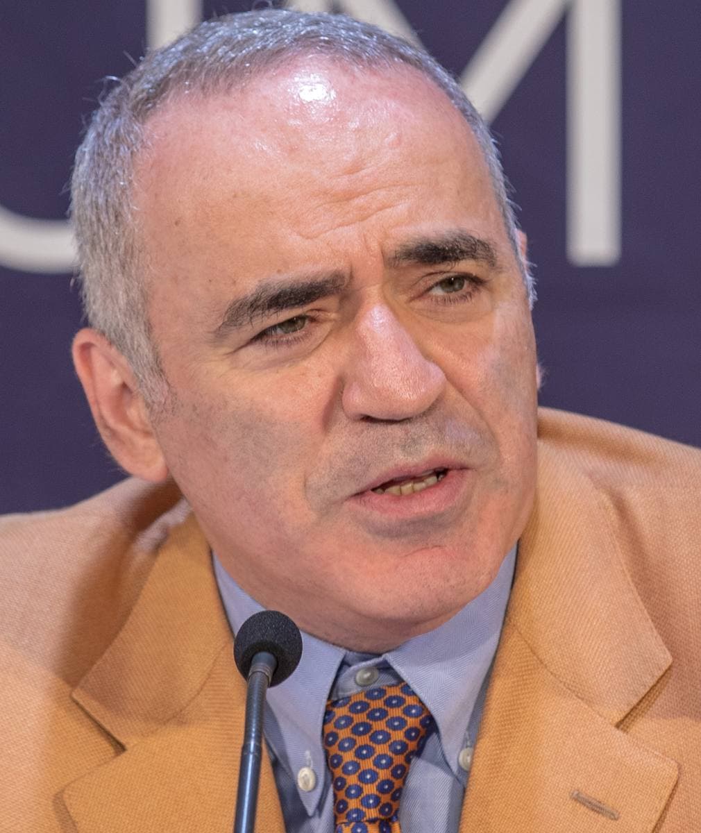Garry Kasparov in a dark jacket at a press conference