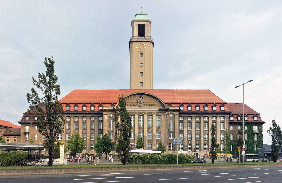A large town hall with a tall square clock tower