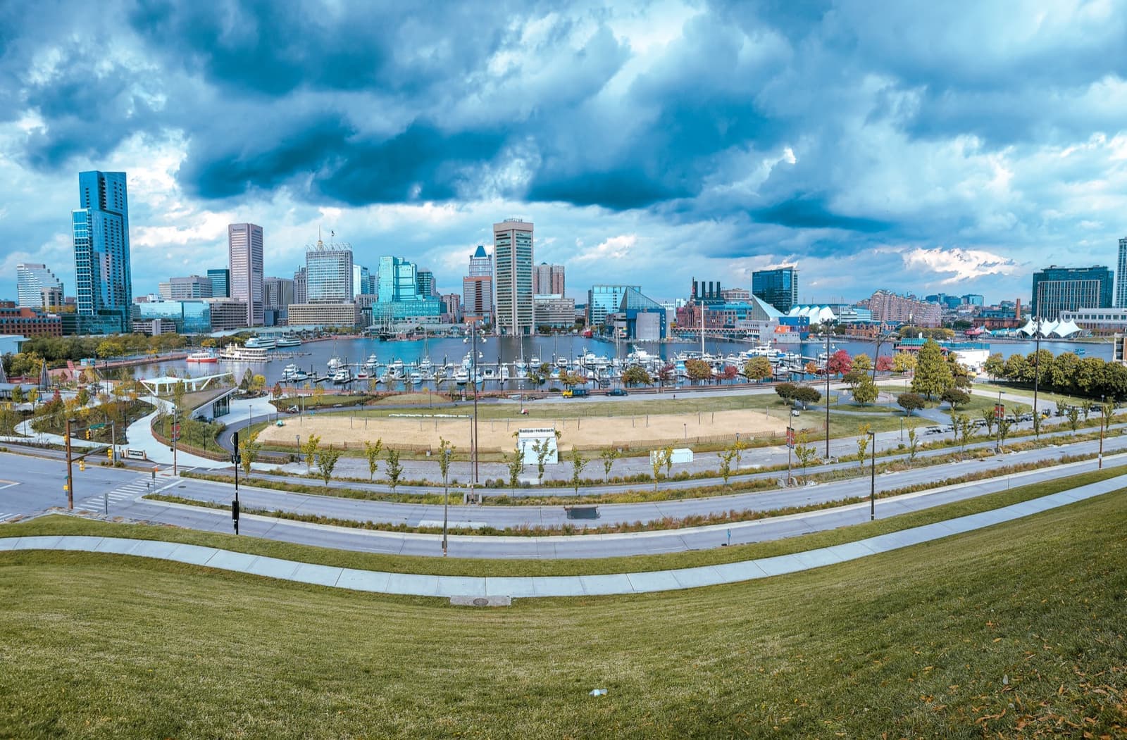 Downtown Baltimore towers under heavy storm clouds, seen across the harbour