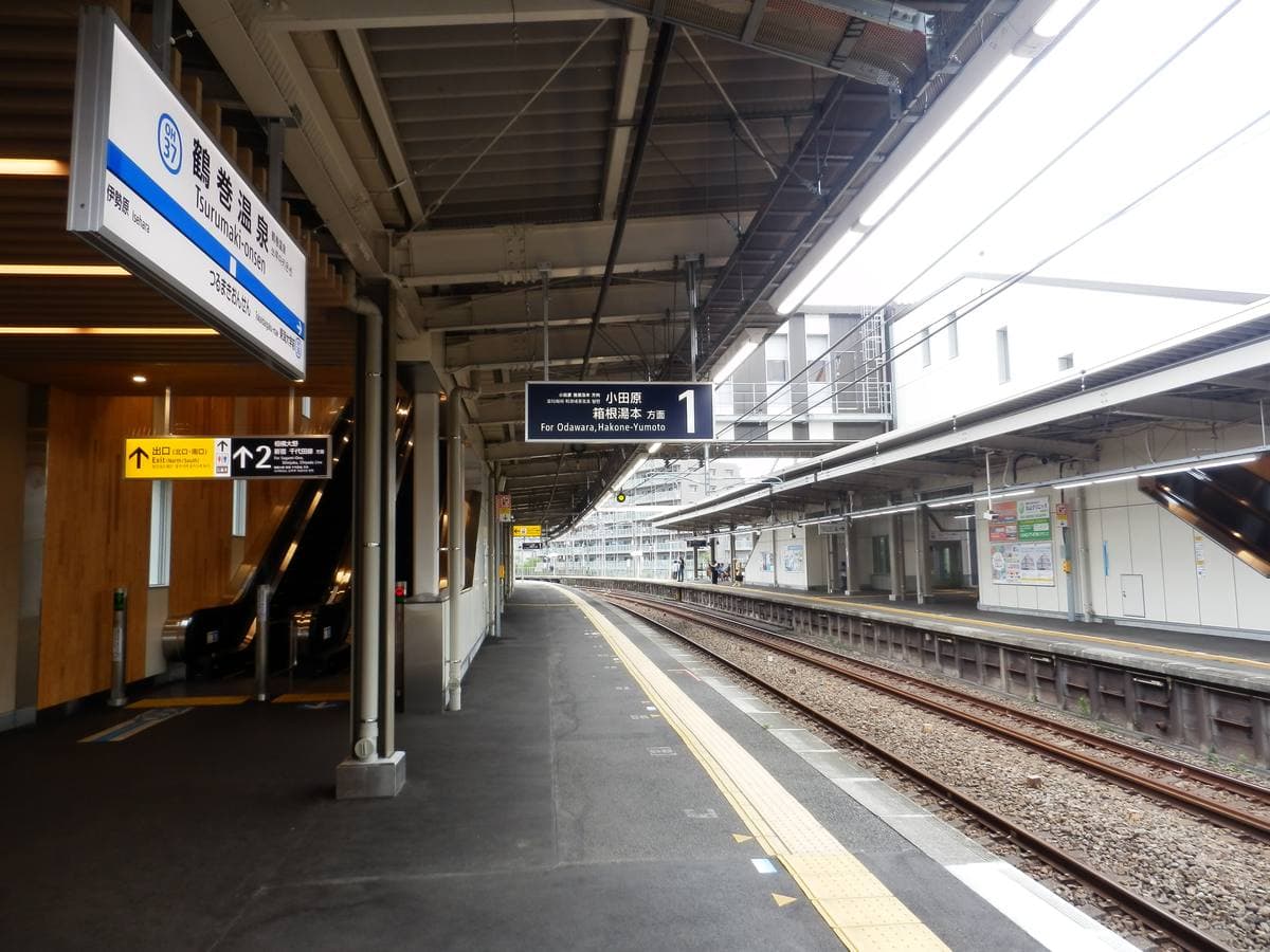 A suburban station platform under a long roof
