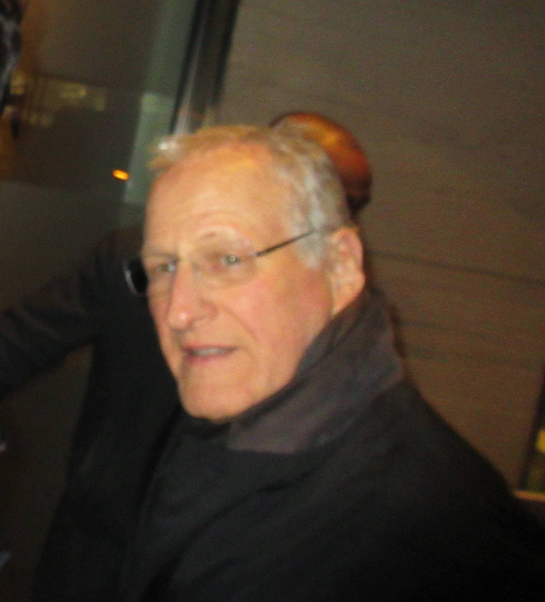 Michael Mann in glasses and a dark coat