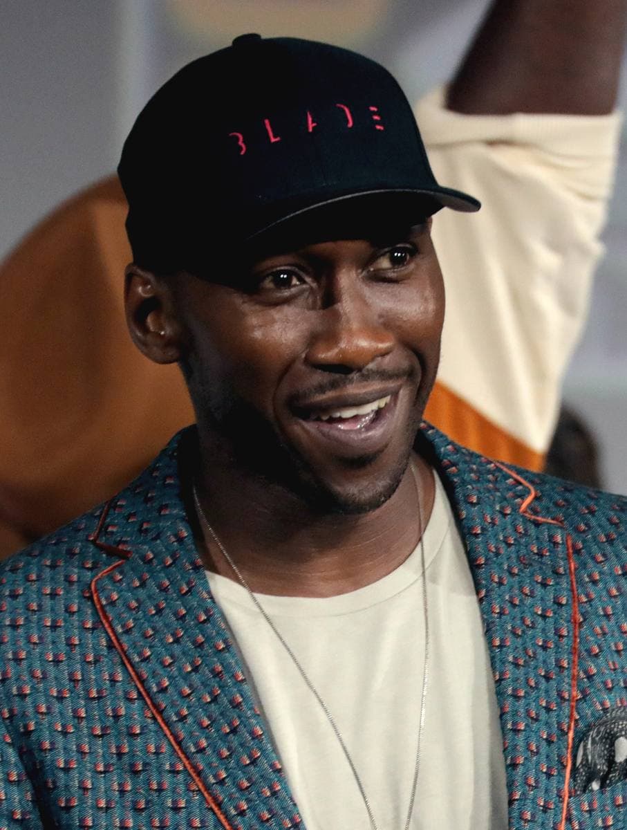 Mahershala Ali speaking into a microphone